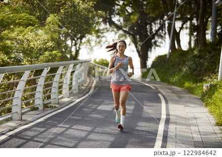 young asian woman jogging running in park young asian woman jogging running in park 122984642