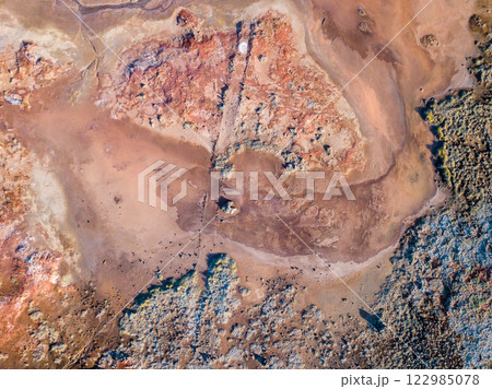 Capturing the vibrant geothermal landscape near Grindavik, Iceland with a drone, highlighting the distinct soil patterns and textures 122985078