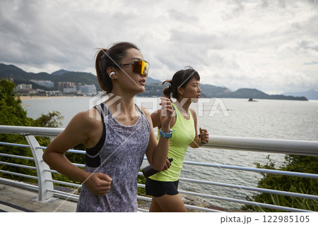 young asian women running jogging outdoors 122985105