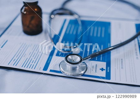stethoscope on a report stethoscope on a clipboard stethoscope on a book stethoscope on a report stethoscope on a clipboard stethoscope on a book 122990989