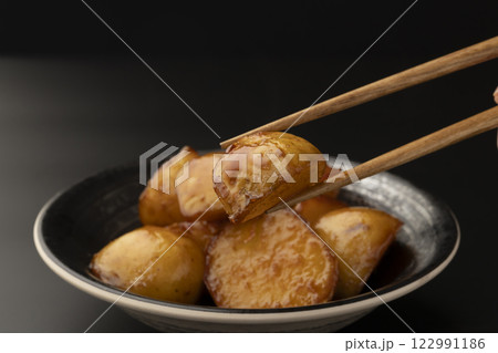 新じゃがの煮っころがしを箸で持ち上げる 122991186