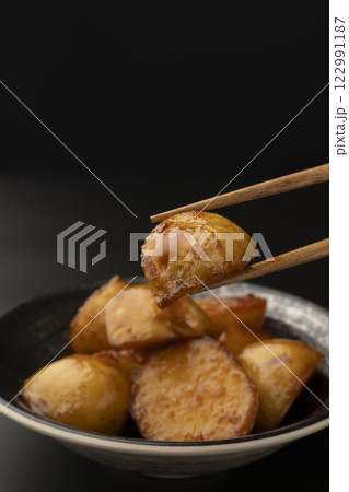 新じゃがの煮っころがしを箸で持ち上げる 新じゃがの煮っころがしを箸で持ち上げる 122991187