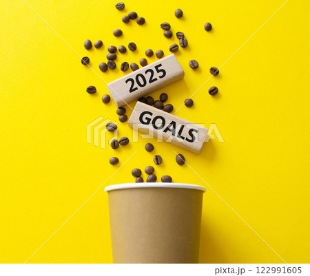 2025 Goals symbol. Concept word 2025 Goals on wooden blocks. Beautiful yellow background with coffee cup. Business and 2025 Goals concept. Copy space. 122991605