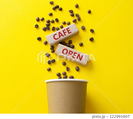 Cafe Open symbol. Concept word Cafe Open on wooden blocks. Beautiful yellow background with coffee cup. Business and Cafe Open concept. Copy space Cafe Open symbol. Concept word Cafe Open on wooden blocks. Beautiful yellow background with coffee cup. Business and Cafe Open concept. Copy space 122991607
