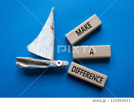 Make a difference symbol. Concept words Make a difference on wooden blocks. Beautiful blue background with boat. Business concept and Make a difference. Copy space. 122991611