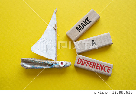 Make a difference symbol. Concept words Make a difference on wooden blocks. Beautiful yellow background with boat. Business concept and Make a difference. Copy space. 122991616