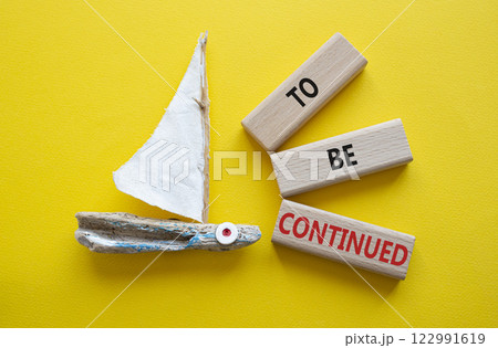 To be continued symbol. Concept words To be continued on wooden blocks. Beautiful yellow background with boat. Business concept and To be continued. Copy space. 122991619
