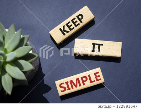 Keep it Simple symbol. Concept words Keep it Simple on wooden blocks. Beautiful deep blue background with succulent plant. Business and Keep it Simple concept. Copy space. Keep it Simple symbol. Concept words Keep it Simple on wooden blocks. Beautiful deep blue background with succulent plant. Business and Keep it Simple concept. Copy space. 122991647