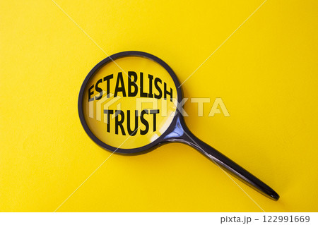 Establish trust symbol. Magnifying Glass with Concept word Establish trust. Beautiful yellow background. Business and Establish trust concept. Copy space Establish trust symbol. Magnifying Glass with Concept word Establish trust. Beautiful yellow background. Business and Establish trust concept. Copy space 122991669