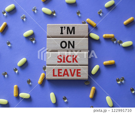 Sick leave symbol. Concept word I am on sick leave on wooden blocks. Beautiful purple background with pills. Medicine and I am on sick leave concept. Copy space Sick leave symbol. Concept word I am on sick leave on wooden blocks. Beautiful purple background with pills. Medicine and I am on sick leave concept. Copy space 122991710