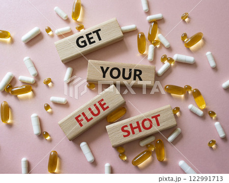 Get your Flue Shot symbol. Concept word Get your Flue Shot on wooden blocks. Beautiful pink background with pills. Medicine Get your Flue Shot concept. Copy space Get your Flue Shot symbol. Concept word Get your Flue Shot on wooden blocks. Beautiful pink background with pills. Medicine Get your Flue Shot concept. Copy space 122991713