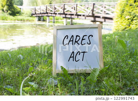 Cares Act symbol. White Blackboard with words Cares Act. Beautiful meadow background with bridge. Business and Cares Act concept. Copy space. Cares Act symbol. White Blackboard with words Cares Act. Beautiful meadow background with bridge. Business and Cares Act concept. Copy space. 122991743