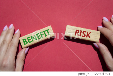 Risk or Benefit symbol. Concept word Risk or Benefit on wooden blocks. Businessman hand. Beautiful red background. Business and Risk or Benefit concept. Copy space Risk or Benefit symbol. Concept word Risk or Benefit on wooden blocks. Businessman hand. Beautiful red background. Business and Risk or Benefit concept. Copy space 122991894