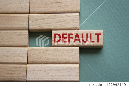 Default symbol. Concept word Default on wooden blocks. Beautiful grey green background. Business and Default concept. Copy space. Default symbol. Concept word Default on wooden blocks. Beautiful grey green background. Business and Default concept. Copy space. 122992140