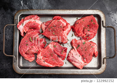 Raw beef boneless shank shin meat with herbs and spices ready for cooking. isolated on white background. top view Raw beef boneless shank shin meat with herbs and spices ready for cooking. isolated on white background. top view 122992152