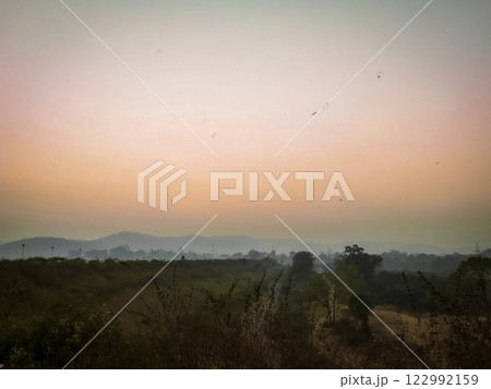 Serene Sunset over Misty Hills Landscape in Patratu, Jharkhand,  122992159