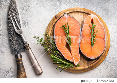 Premium salmon loin steak, expertly cut and displayed, perfect for culinary creations. Elevate your dishes with this delicious seafood option. grey background. top view Premium salmon loin steak, expertly cut and displayed, perfect for culinary creations. Elevate your dishes with this delicious seafood option. grey background. top view 122992188