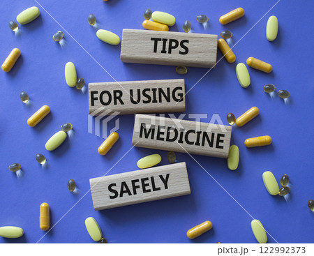 Medicine symbol. Concept word Taking drugs the right way on wooden blocks. Beautiful purple background with pills. Medicine concept. Copy space Medicine symbol. Concept word Taking drugs the right way on wooden blocks. Beautiful purple background with pills. Medicine concept. Copy space 122992373
