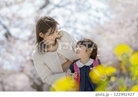 桜と菜の花の咲く公園を楽しむ入学の娘と母親 桜と菜の花の咲く公園を楽しむ入学の娘と母親 122992427