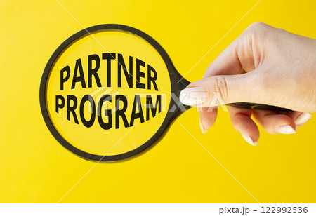 Partner Program symbol. Concept words Partner Program on magnifying glass. Businessman hand. Beautiful yellow background. Business and Partner Program concept. Copy space. Partner Program symbol. Concept words Partner Program on magnifying glass. Businessman hand. Beautiful yellow background. Business and Partner Program concept. Copy space. 122992536