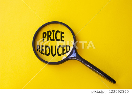 Price reduced symbol. Magnifying Glass with Concept word Price reduced. Beautiful yellow background. Business and Price reduced concept. Copy space Price reduced symbol. Magnifying Glass with Concept word Price reduced. Beautiful yellow background. Business and Price reduced concept. Copy space 122992590