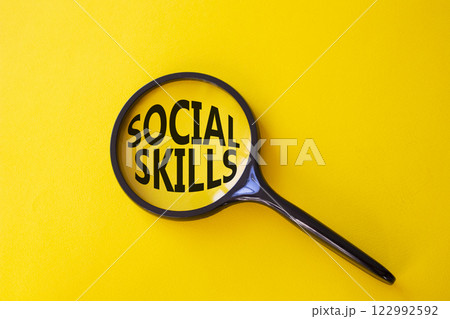 Social skills symbol. Concept words Social skills on magnifying glass. Beautiful yellow background. Business and Social skills concept. Copy space. 122992592