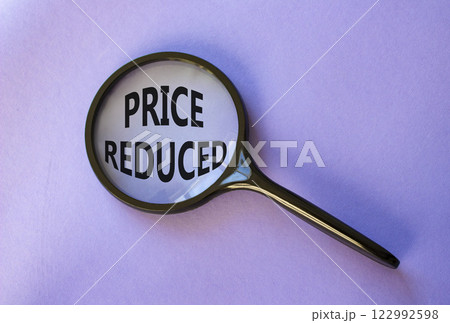 Price reduced symbol. Magnifying Glass with Concept word Price reduced. Beautiful purple background. Business and Price reduced concept. Copy space Price reduced symbol. Magnifying Glass with Concept word Price reduced. Beautiful purple background. Business and Price reduced concept. Copy space 122992598