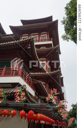 Roof detail of Buddha Tooth Relic Temple in Singapore, showcasing its intricate red architecture Roof detail of Buddha Tooth Relic Temple in Singapore, showcasing its intricate red architecture 122992699