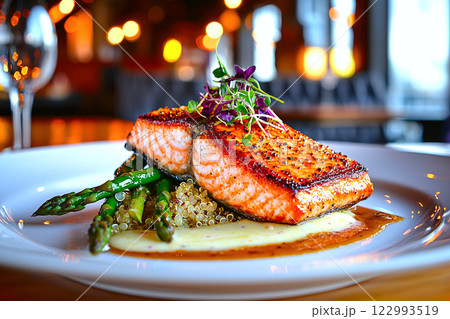 Grilled salmon with steamed asparagus and quinoa, elegantly plated for a high protein wellness meal 122993519