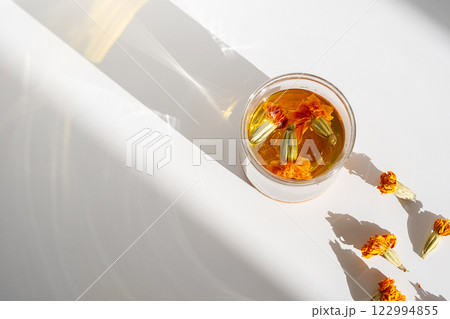Glass of Wholesome Marigold Herbal Tea. Glass of Wholesome Marigold Herbal Tea. 122994855