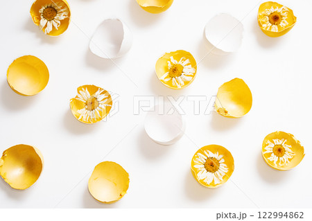 Cracked Easter Eggs with Flowers Inside. 122994862