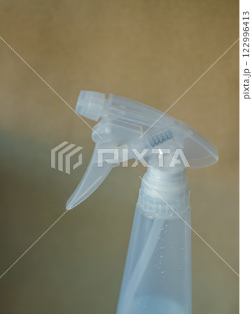Close-up of a clear plastic spray bottle trigger, showcasing its mechanism . High quality photo 122996413