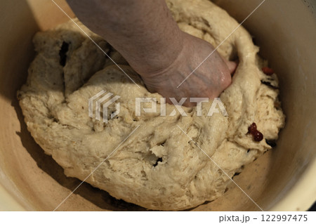 female hands knead yeast dough for baking 122997475
