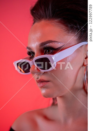 A Trendy Portrait of a Stylish Woman Wearing Chic Sunglasses That Exude Confidence and Attitude A Trendy Portrait of a Stylish Woman Wearing Chic Sunglasses That Exude Confidence and Attitude 122997789