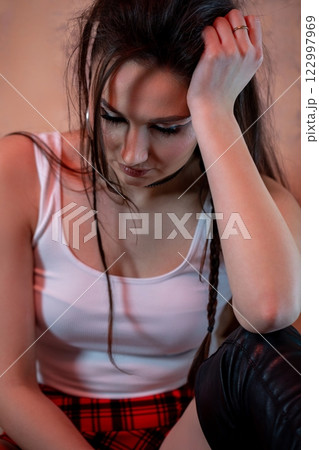 A Contemplative Young Woman in a Casual and Relaxed Setting, Evoking Deep Emotions A Contemplative Young Woman in a Casual and Relaxed Setting, Evoking Deep Emotions 122997969