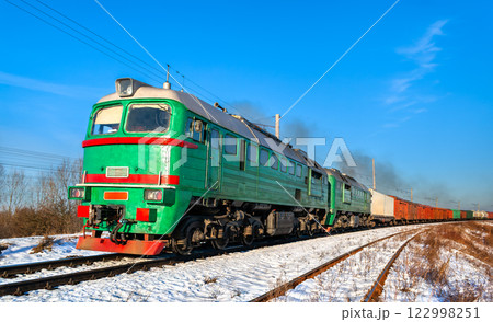Diesel locomotive with a heavy freight train in winter in Kovel, Volyn Oblast of Ukraine 122998251