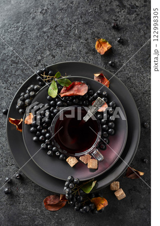 Black chokeberry juice, fresh berries, and pieces of brown sugar. 122998305