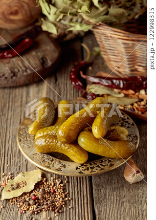 Pickled cucumbers with ingredients on an old wooden table. Pickled cucumbers with ingredients on an old wooden table. 122998315