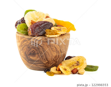 Dried tropical fruits, nuts, and raisins isolated on white. Dried tropical fruits, nuts, and raisins isolated on white. 122998353