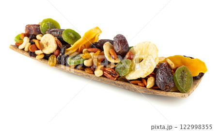 Dried tropical fruits, nuts, and raisins isolated on white. Dried tropical fruits, nuts, and raisins isolated on white. 122998355