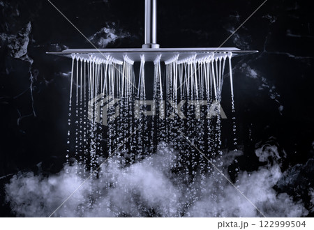 Shower head Providing Elegant Water Flow in Luxurious Bathroom Setting Shower head Providing Elegant Water Flow in Luxurious Bathroom Setting 122999504