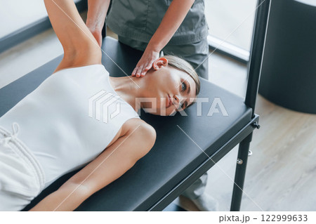 Using special equipment. Woman is in health center getting help by doctor Using special equipment. Woman is in health center getting help by doctor 122999633