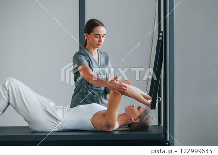 Using special equipment. Woman is in health center getting help by doctor 122999635