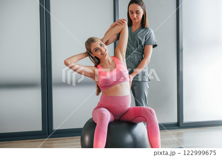 Pregnant woman is in health center getting help by doctor 122999675