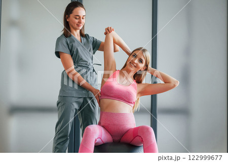 Pregnant woman is in health center getting help by doctor Pregnant woman is in health center getting help by doctor 122999677