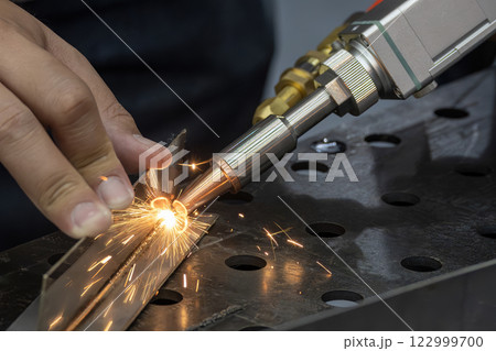 Close up scene the portable laser welding machine operation. 122999700