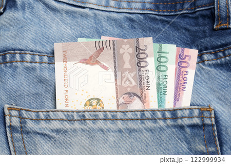 Aruban florin in the pocket of blue jeans 122999934