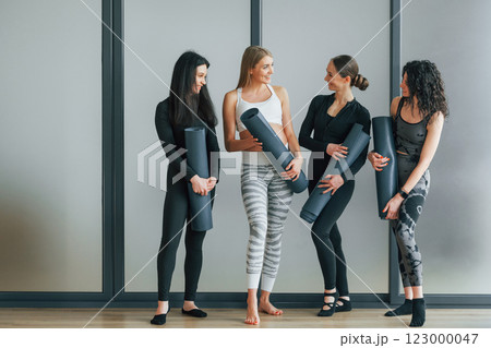 Four people. Women in sportive clothes standing in the fitness center Four people. Women in sportive clothes standing in the fitness center 123000047