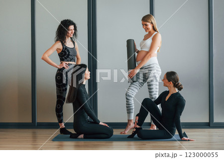 Yoga session. Women in sportive clothes standing in the fitness center 123000055