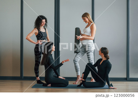 Yoga session. Women in sportive clothes standing in the fitness center 123000056